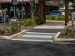 An unmarked, raised pedestrian island crossing in Brisbane, Australia