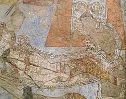 Injured Amazon carried on a stretched by two male attendants.