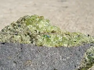Peridot olivine with minor pyroxene, on vesicular basalt. (field of view = 35 mm)