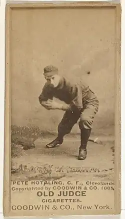Man in baseball uniform bending down