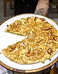 Banana nevada (lit. 'snowy banana'; mozzarella, banana slices, white chocolate) pizza being served at a rodízio restaurant