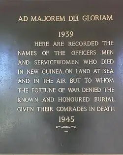 Photo of plaque between panels at the Lae Memorial at the Lae War Cemetery