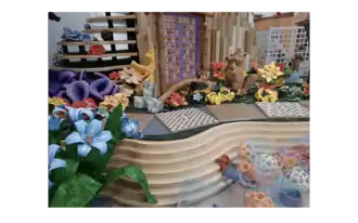 Mathematically-inspired flora and fauna fill the garden and reef as two squirrels discuss prime number algorithms in front of their Sieve of Eratosthenes