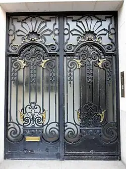 Door of Rue Guynemer no. 2, Paris, with palmettes, shells, volutes, garlands, proportions and other elements seen on wrought iron, furniture, textiles and ceramics from the reign of Louis XIV
