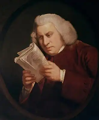 Man staring intently at a book held close to his face