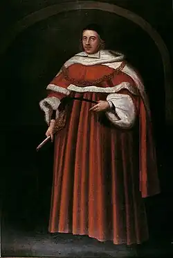 A Portrait of Matthew Hale. He stands in a full-length brown judge's robe with a black cap on his head. In his right hand, he holds a paintbrush.