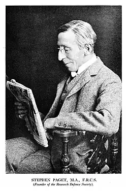 Portrait of Stephen Paget reading a newspaper