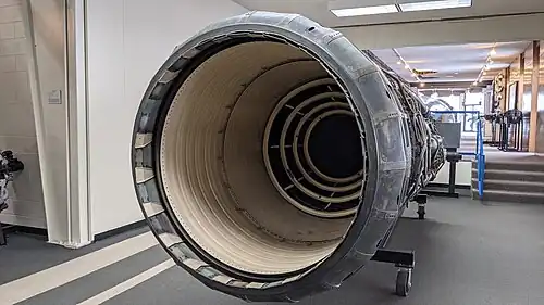 The afterburner was rated for continuous operation at 3,200 °F (1,800 °C) made possible with ceramic coatings (colored white) on duct liner and flame holders[85] and compressor bleed air cooling the duct and nozzle (above Mach 2.1 when the bleed was flowing). The nozzle is fully open, the maximum afterburning position. The main purpose of the variable nozzle area was to control engine operation which it did in conjunction with varying heat release in the afterburner.