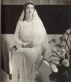 Black and white photograph of a young woman in a wedding dress.