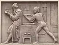 Detail of second bas-relief: Gutenberg at a printing press