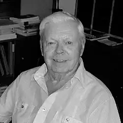 Bust-length black-and-white photo of Prévost; he is wearing a white shirt