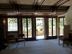 A view of the dining room, looking toward an exterior terrace