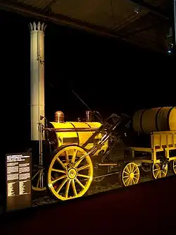 Small, bright yellow, steam locomotive