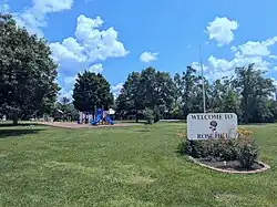 Welcome sign and city park