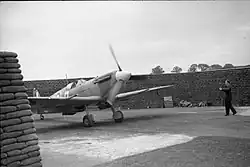 Circular airfield dispersal protected by a high wall of filled sandbags in a C layout