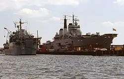 Sir Bedivere docked alongside a Royal Navy aircraft carrier in Portsmouth, 1989.