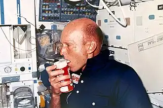 Gordon Fullerton, STS-51F mission commander, with a Coca-Cola can