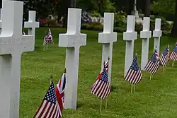 White grave markers with flags
