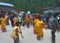 A boy holding qpod-qpod performing cakalele mbreh dance in Fakfak, West Papua