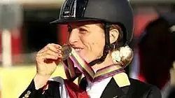 Photo of Morganti smiling while holding a medal