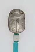 Silver scarab with gold hieroglyphs