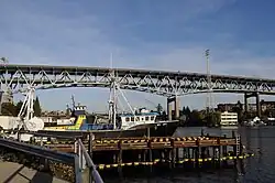 A steel bridge with two decks crossing high above a body of water