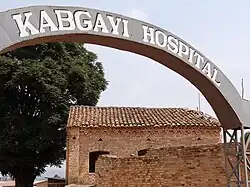 Sign with Colonial-Era Building – Kabgayi Hospital