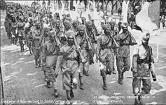 Postcard of marching Sikhs with rifles