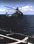 Two Sikorsky UH-34D of HMM-162 approach USS Guam for landing in 1967.