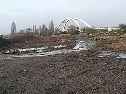 A cleared building site with the City Bridge in the background
