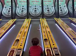 Child playing skee-ball.