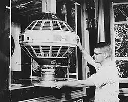 A researcher examines the Vanguard I satellite.