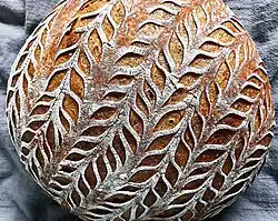 Sourdough bread scored with lame, after baking