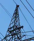 Detail view of a pinnacle of a pylon equipped with two garland-like communication cables