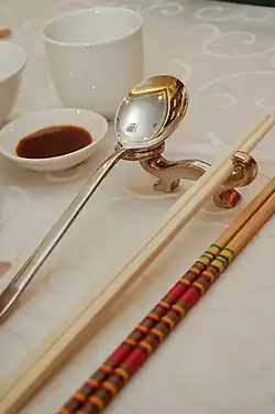 Image 30Photo showing serving chopsticks (gongkuai) on the far right, personal chopsticks (putongkuai) in the middle, and a spoon. Serving chopsticks are usually more ornate than the personal ones. (from Chinese culture)
