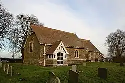 St Wilfrid's Church, Thornton-by-Horncastle, Lincolnshire, general restoration by Ewan Christian in 1890, the timber south porch and timber bell frame in the gable are probably his work[169]
