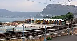 A seaside scene, with a bay and a high mountain in the background