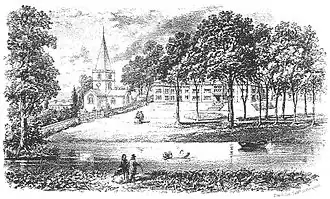 a church and a large house near the bank of a river