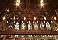 Wooden ceiling and the eastern wall of stained glass windows