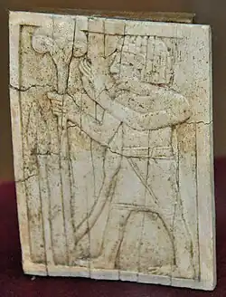 Standing man holding a lotus flower.