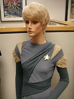 A photo of a mannequin wearing a costume, wig, and ear prosthetics
