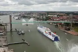 The Älvsborg Bridge, with Gothenburg in the distance. The Toppsockerfabrik is on the right, partially obscured by the deck of the bridge.
