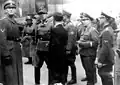 SS Major General Juergen Stroop (second from left) gathers information from a civilian on the second day of the suppression of the Warsaw Ghetto Uprising. Accompanying Stroop are the various officers of his command staff.Left to right SS Fuehrer Franz Konrad (left);Juergen Stroop; Stroop's police adjutant, Karl Kaleske (Kaleschke) (partially hidden);SS Lieutenant (Untersturmfuehrer) Karl Brandt (third from right) SS Lieutenant (Untersturmfuehrer) Schwarz (second from right), and lieutenant (Untersturmfuehrer) in the SD 20 April 1943
