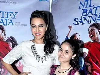 Bhaskar and Shukla smiling at the camera.