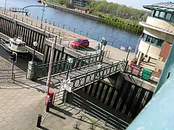 Bascule lifting bridge over the waters of the entrance to the barrage lock.