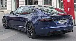 Rear three-quarters view of a blue Tesla Model S