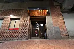 A doorway in a brick building on a brick alleyway