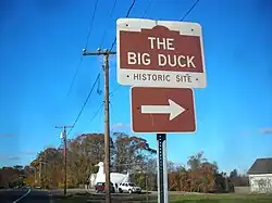 Roadside sign reading "The Big Duck" and below that, "Historic Site", with an arrow pointing to the right.