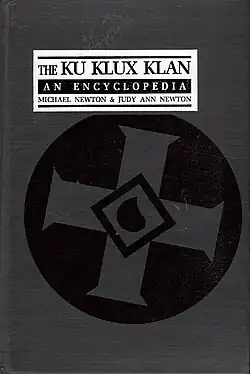 Grey cover with a Ku Klux Klan insignia in the center