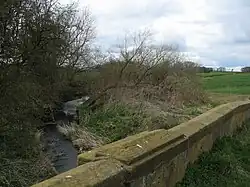 The River Wiske flowing under the old A167 bridge., 54°25′36″N 1°27′54″W﻿ / ﻿54.426645; -1.465125
